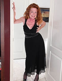 Redheaded and 48 year old Tami Estelle strips nake and spreads wide
