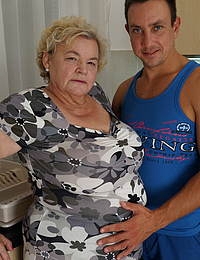 Curvy granny having fun with her toy boy in the kitchen