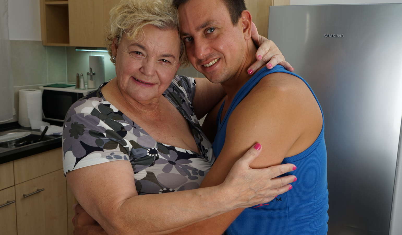 Curvy granny having fun with her toy boy in the kitchen 